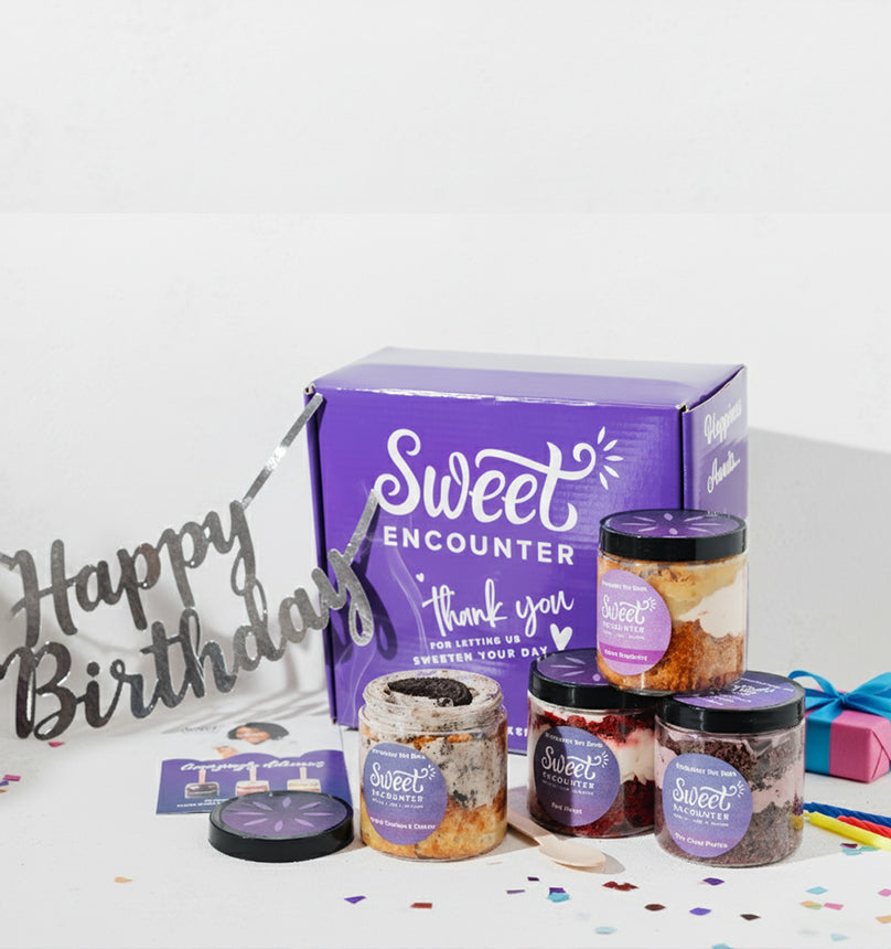 Gift set with 'Sweet Encounter' jars and a purple box on a white background