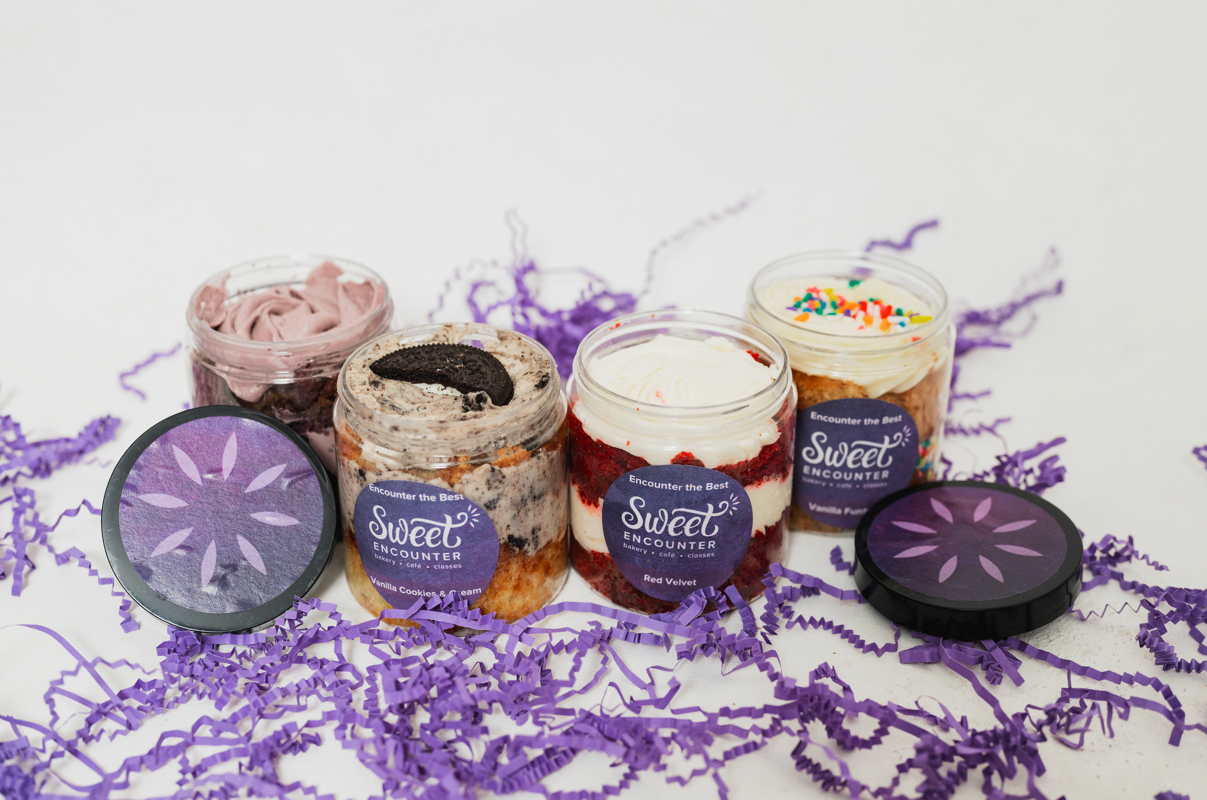 Cupcakes in Jars labeled 'Sweet Encounter' on a white background with purple accents