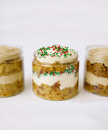 Three jars of layered dessert with a white background